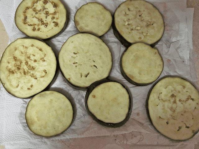 Eggplant slices on a paper towel