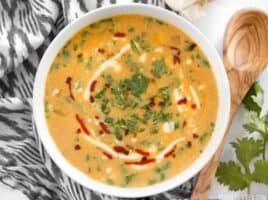 This Spicy Coconut and Pumpkin Soup is perfectly balanced with creamy coconut milk, spicy red pepper flakes and pumpkin's natural subtle sweetness. BudgetBytes.com