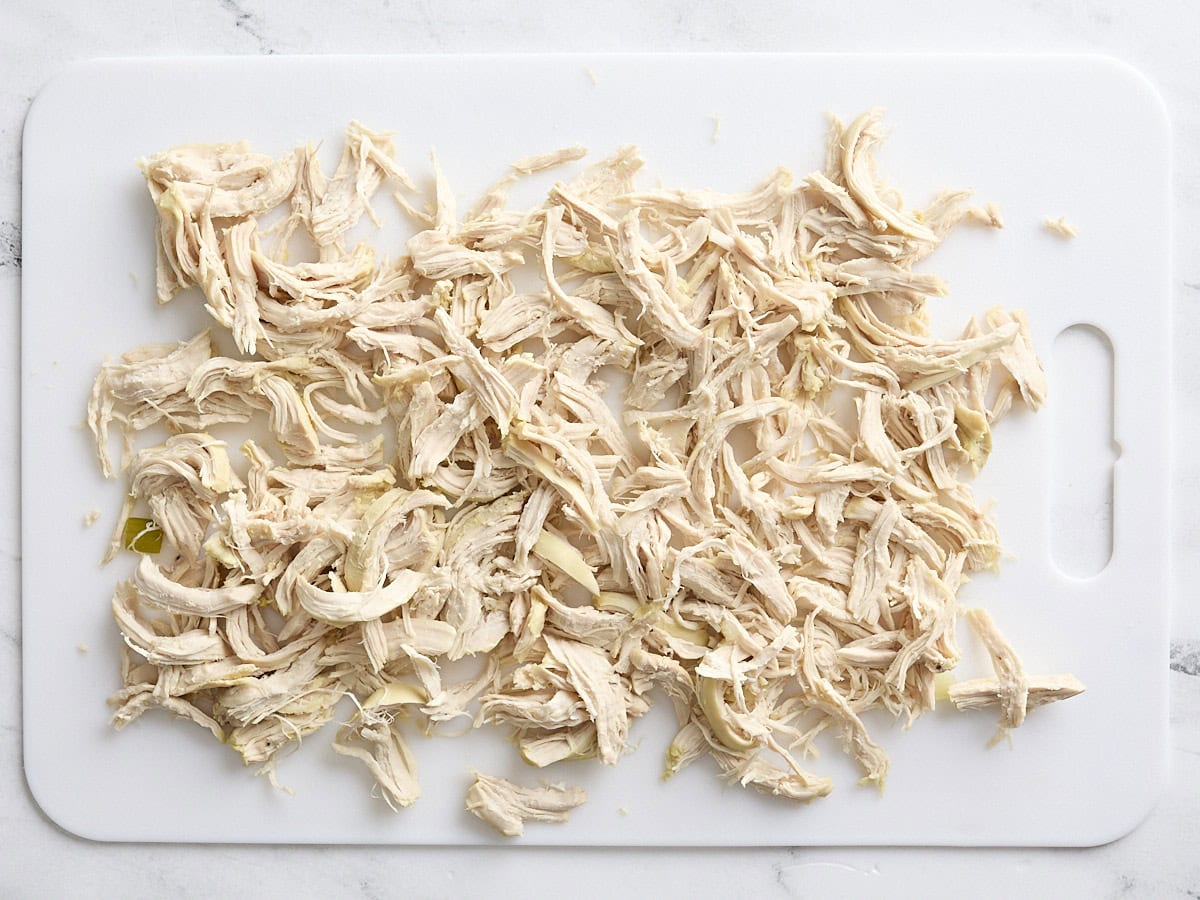 Shredded chicken on a cutting board.