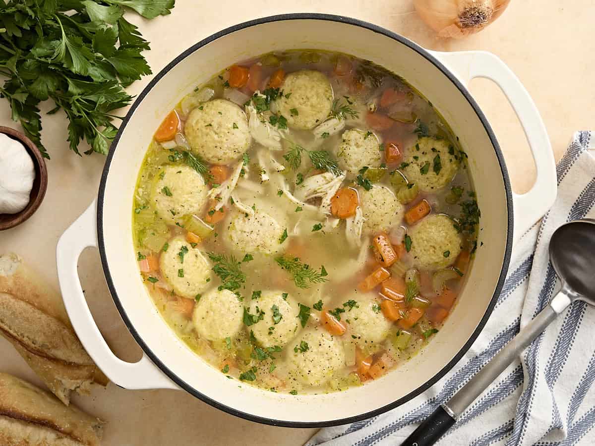 Overhead view of a sauce pot of matzo ball soup.