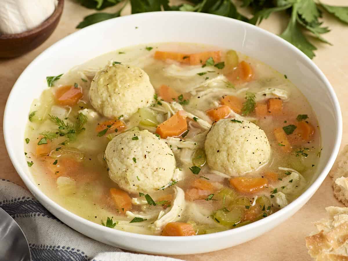 Side view of matzo ball soup in a bowl.