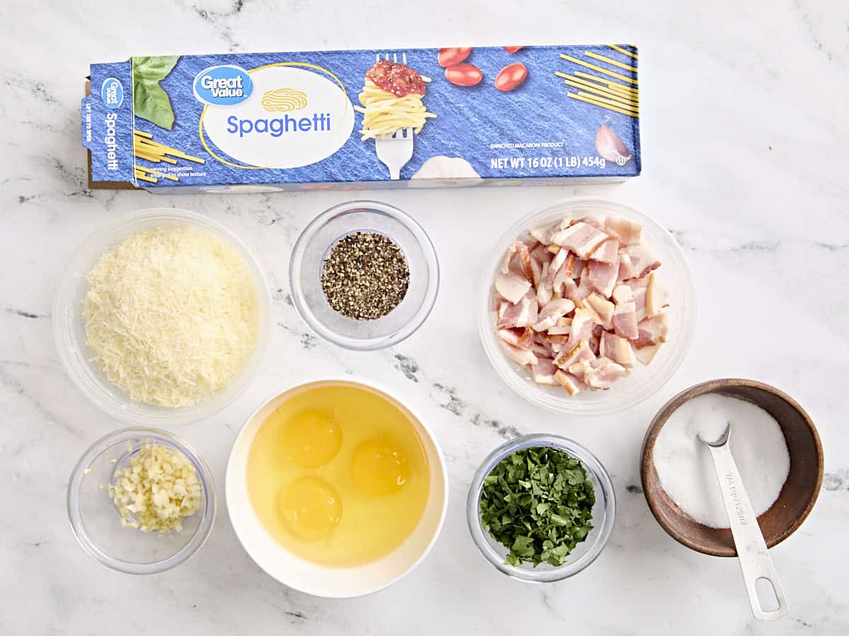 Overhead view of the ingredients for spaghetti carbonara. 