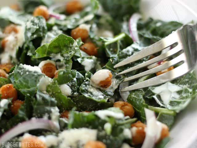 Close up of a fork about to dig into the Kale Salad with Cajun Spiced Chickpeas and Buttermilk Dressing