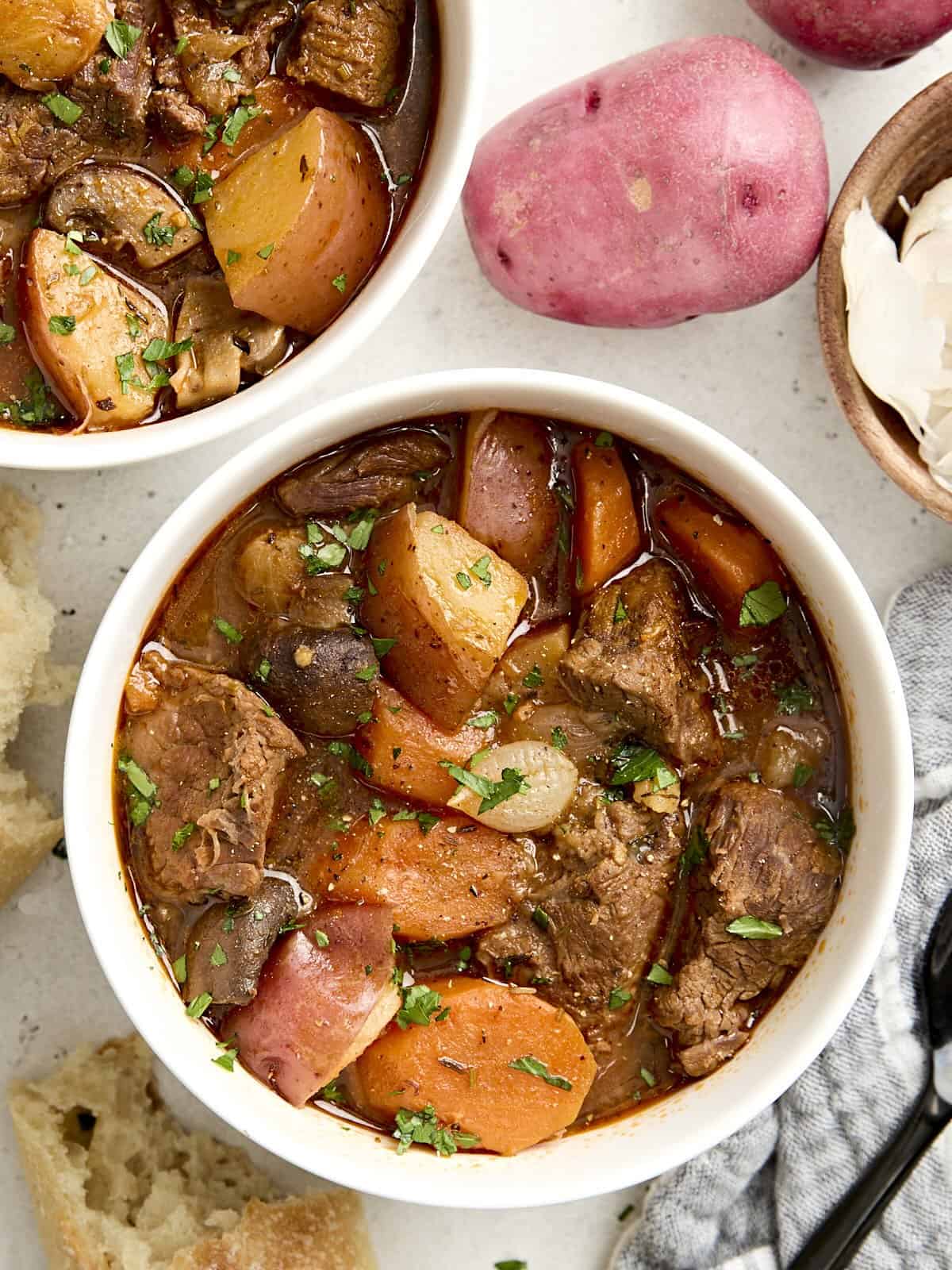 Overhead view of two bowls of Instant Pot beef stew.