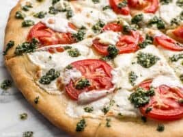 Take your Marghertia pizza up a level with a drizzle of zesty parsley pesto. This white pizza is anything but boring. BudgetBytes.com