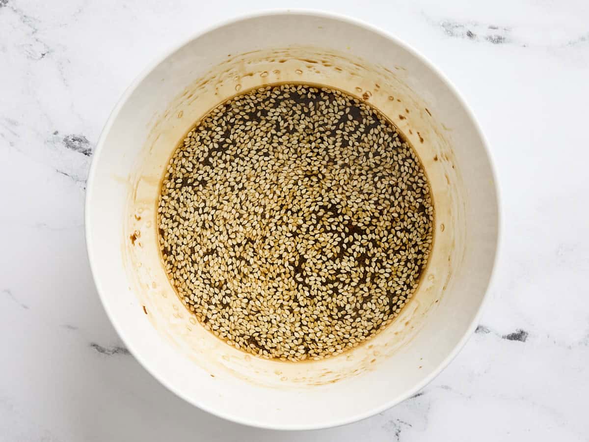 Soy sauce, sesame seeds and seasonings in a bowl.