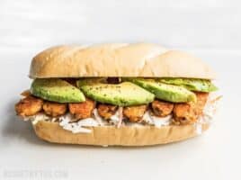 Buffalo Tempeh Sandwich on a Cutting Board