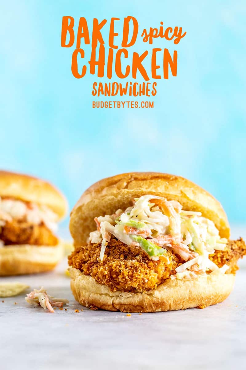 Front view of a Baked Spicy Chicken Sandwich topped with coleslaw against a blue background, title text overlay at top.