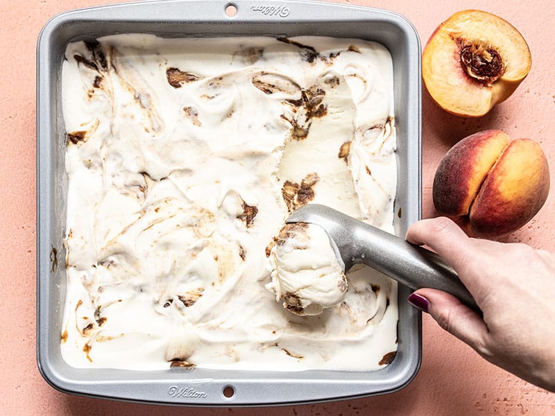 No Churn Balsamic Peach Ice Cream being scooped out of the freezer dish.