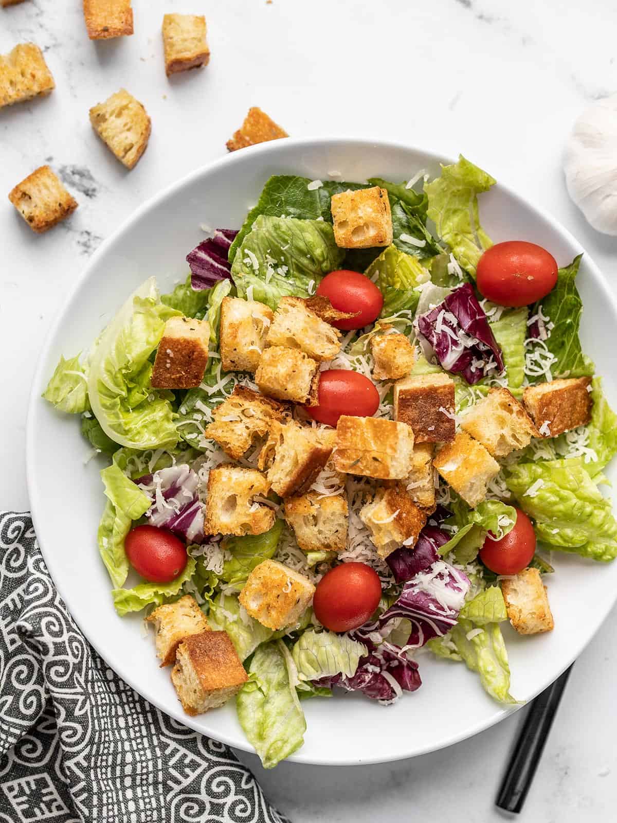 Overhead view of a salad topped with homemade croutons.