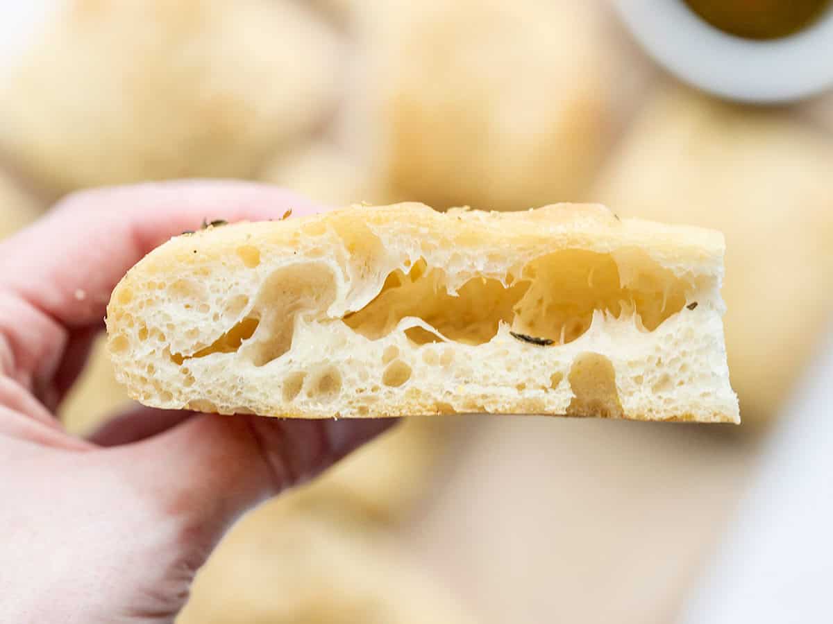 Close up of one slice of focaccia bread showing off the internal bubbles. 