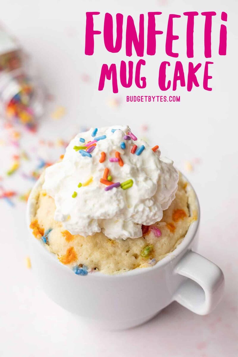 a funfetti mug cake topped with whipped cream, pink title text at the top