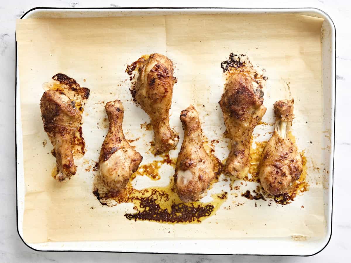 Overhead view of baked chicken drumsticks.