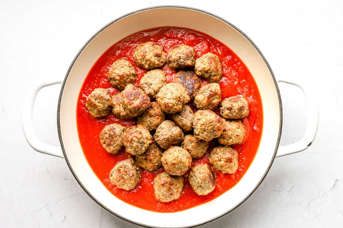 Cooked meatballs in marinara sauce.