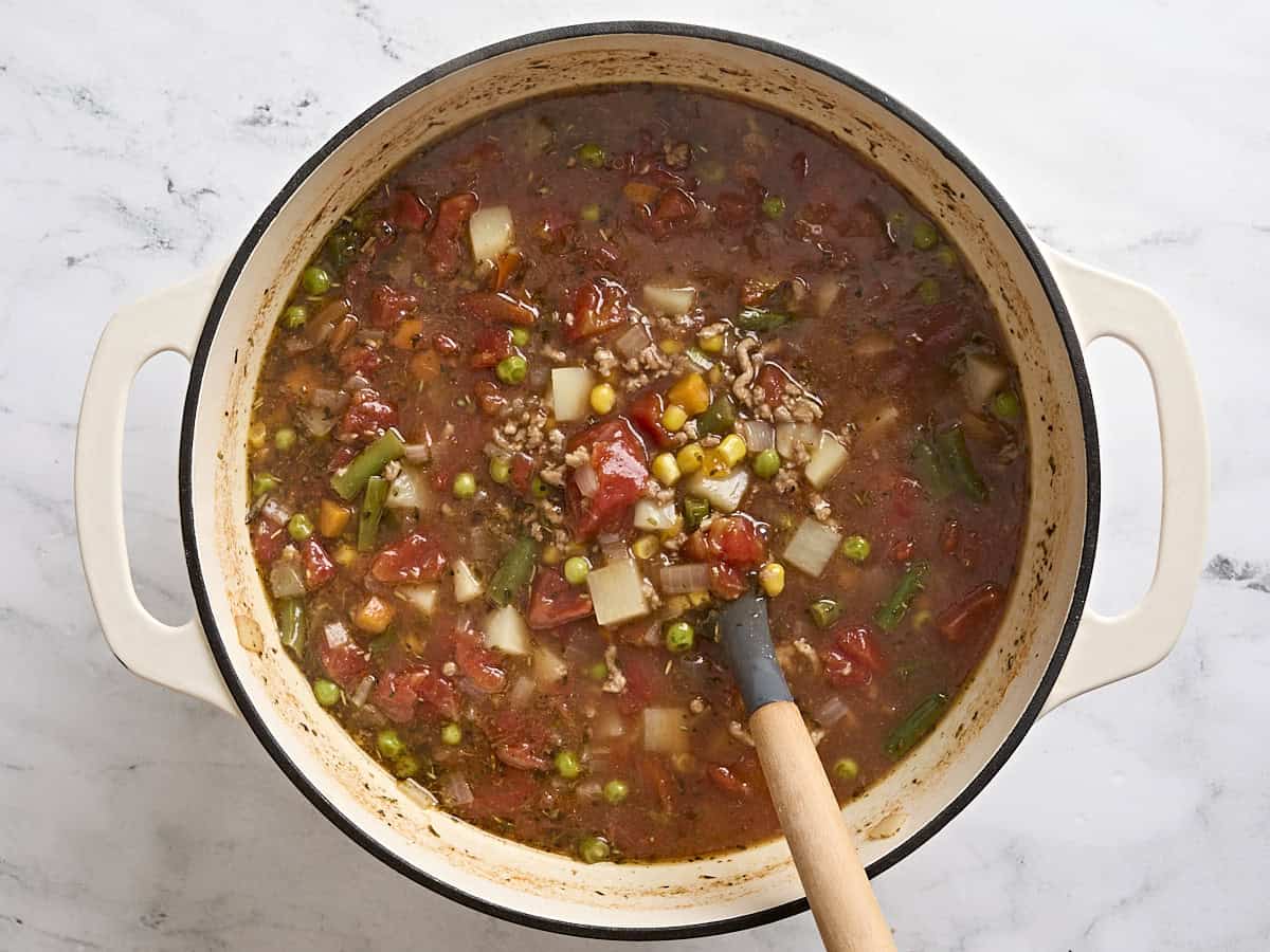 Finished homemade vegetable beef soup in a soup pot.