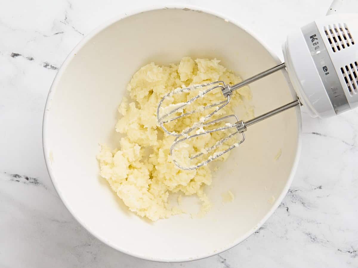 Creamed butter and sugar in a mixing bowl with a handmixer.