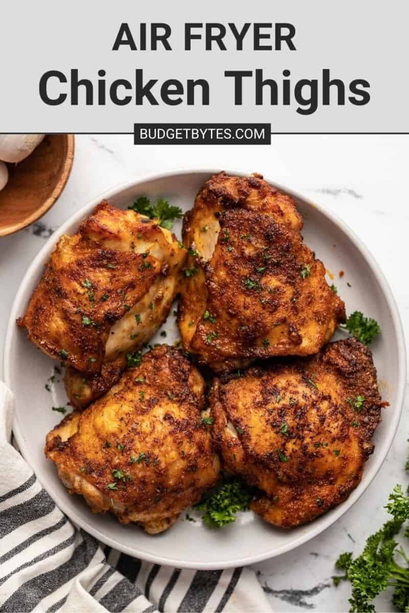 Overhead view of a plate full of air fryer chicken thighs.