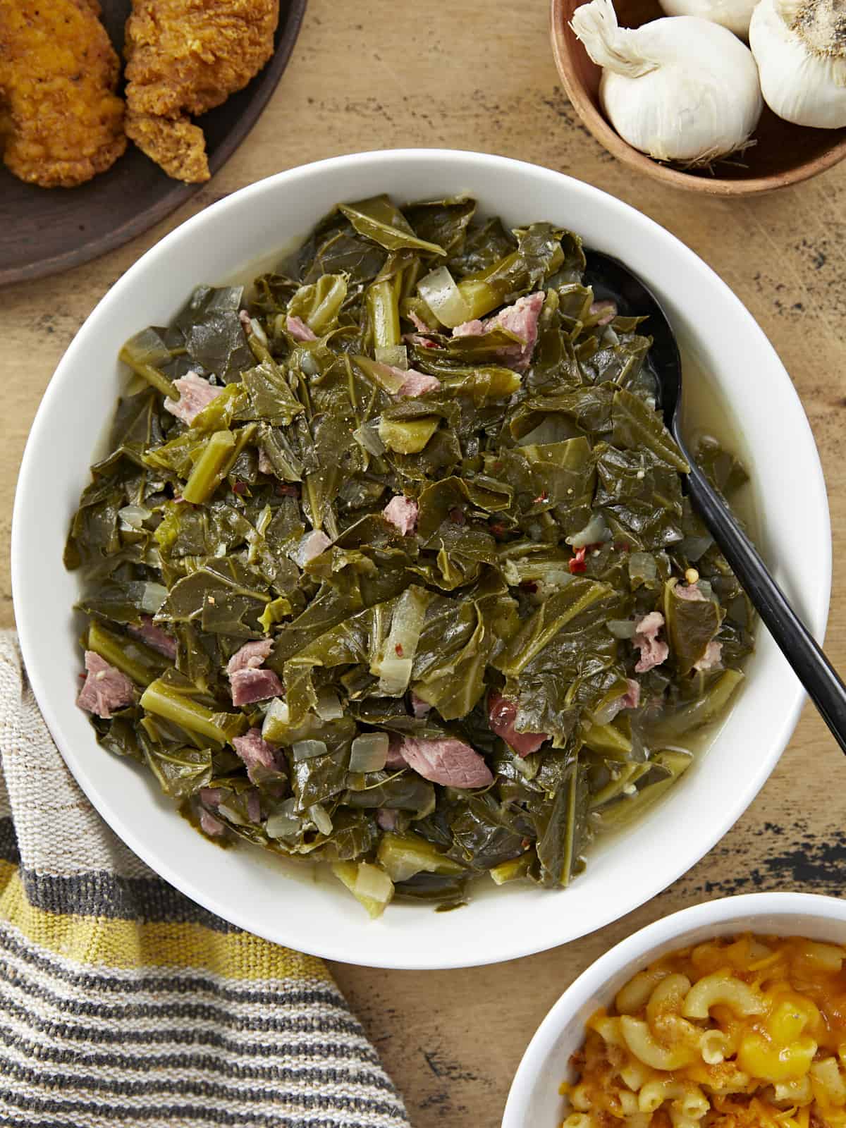 Overhead view of a bowl full of collard greens with ham.