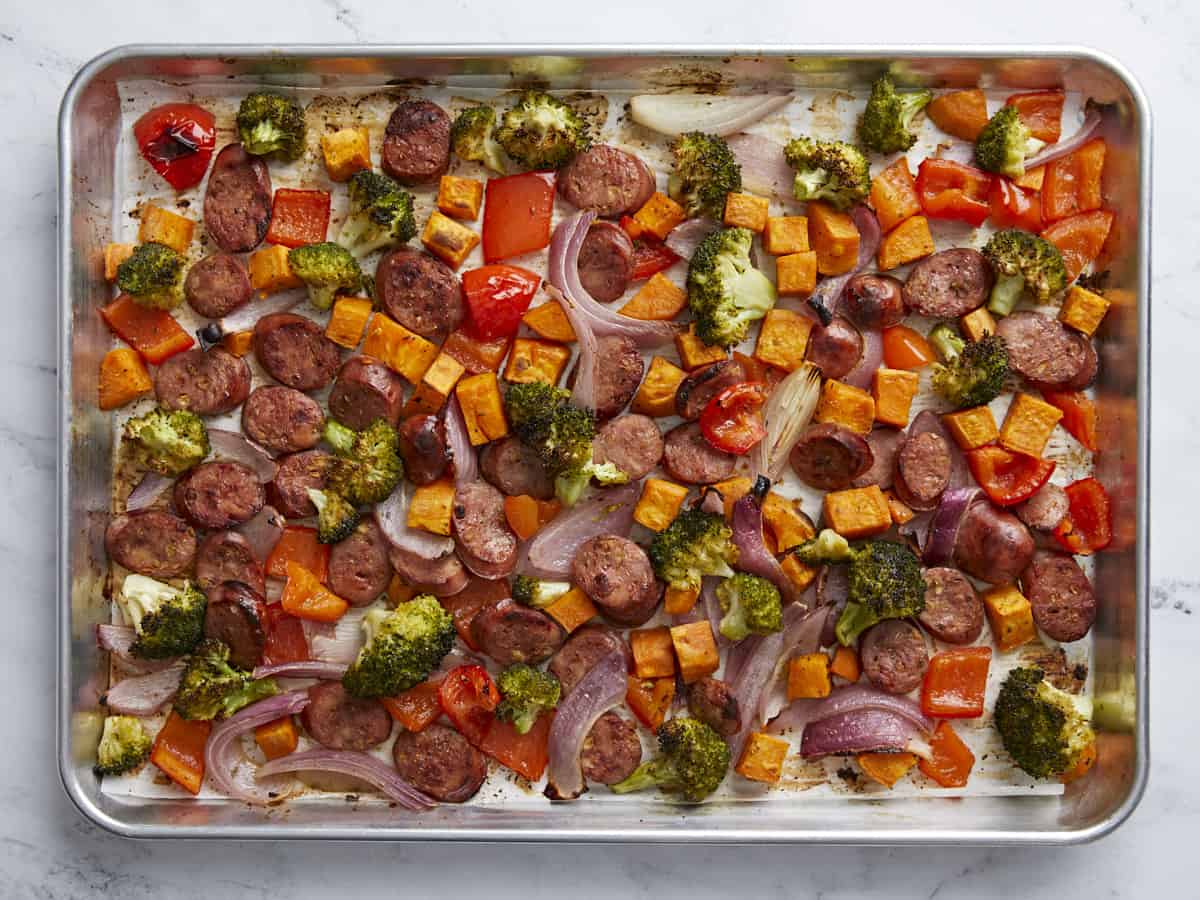 Roasted chicken sausage and vegetables on a sheet pan.