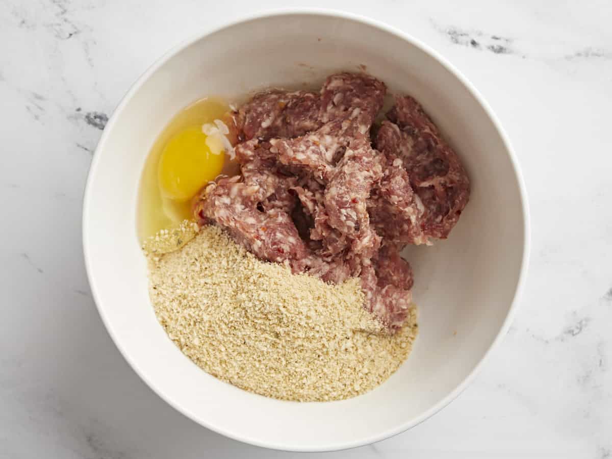 Bowl with meat, breadcrumbs, and egg.