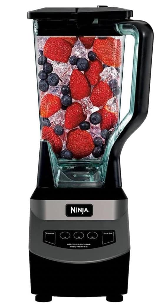 Side view of a Ninja blender full of berries.