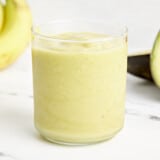 an avocado smoothie in a clear glass.