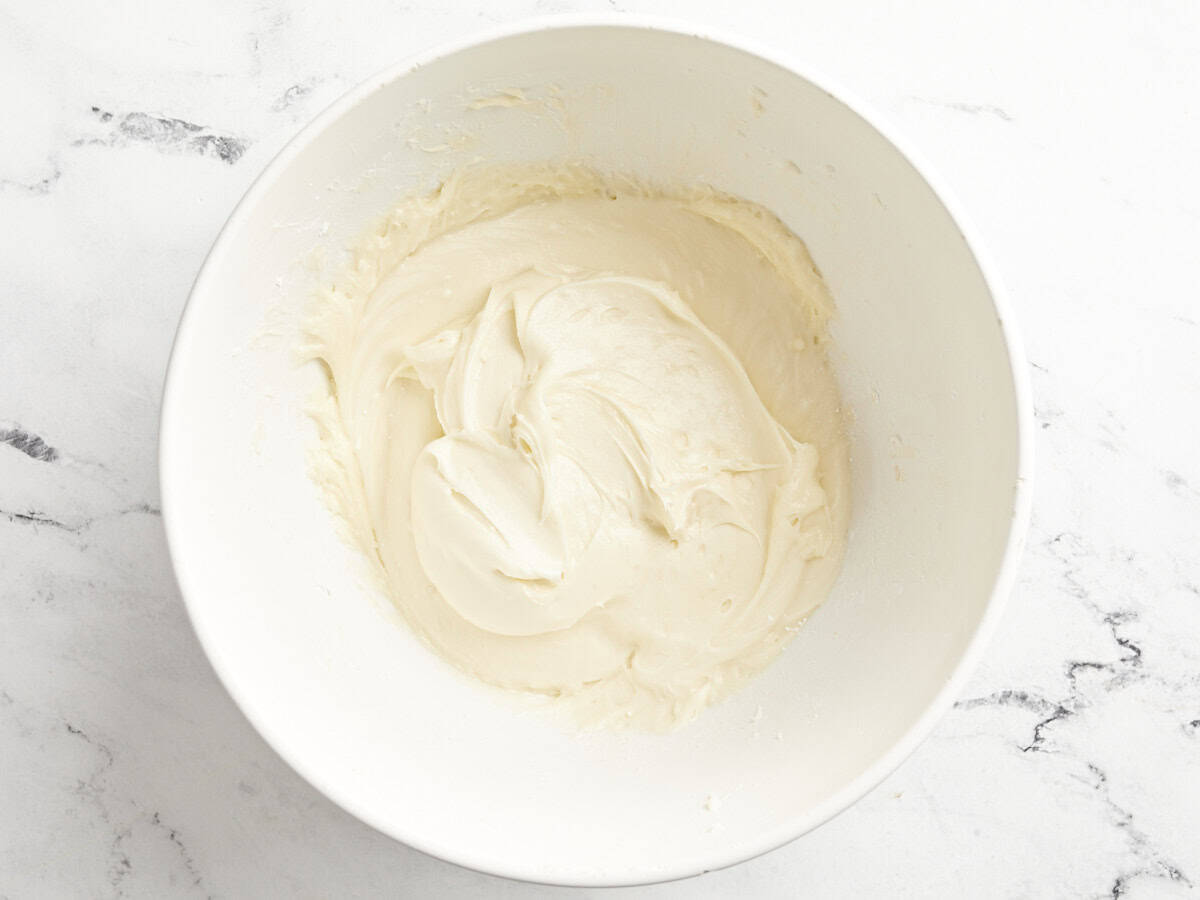 cream cheese frosting in a white bowl.