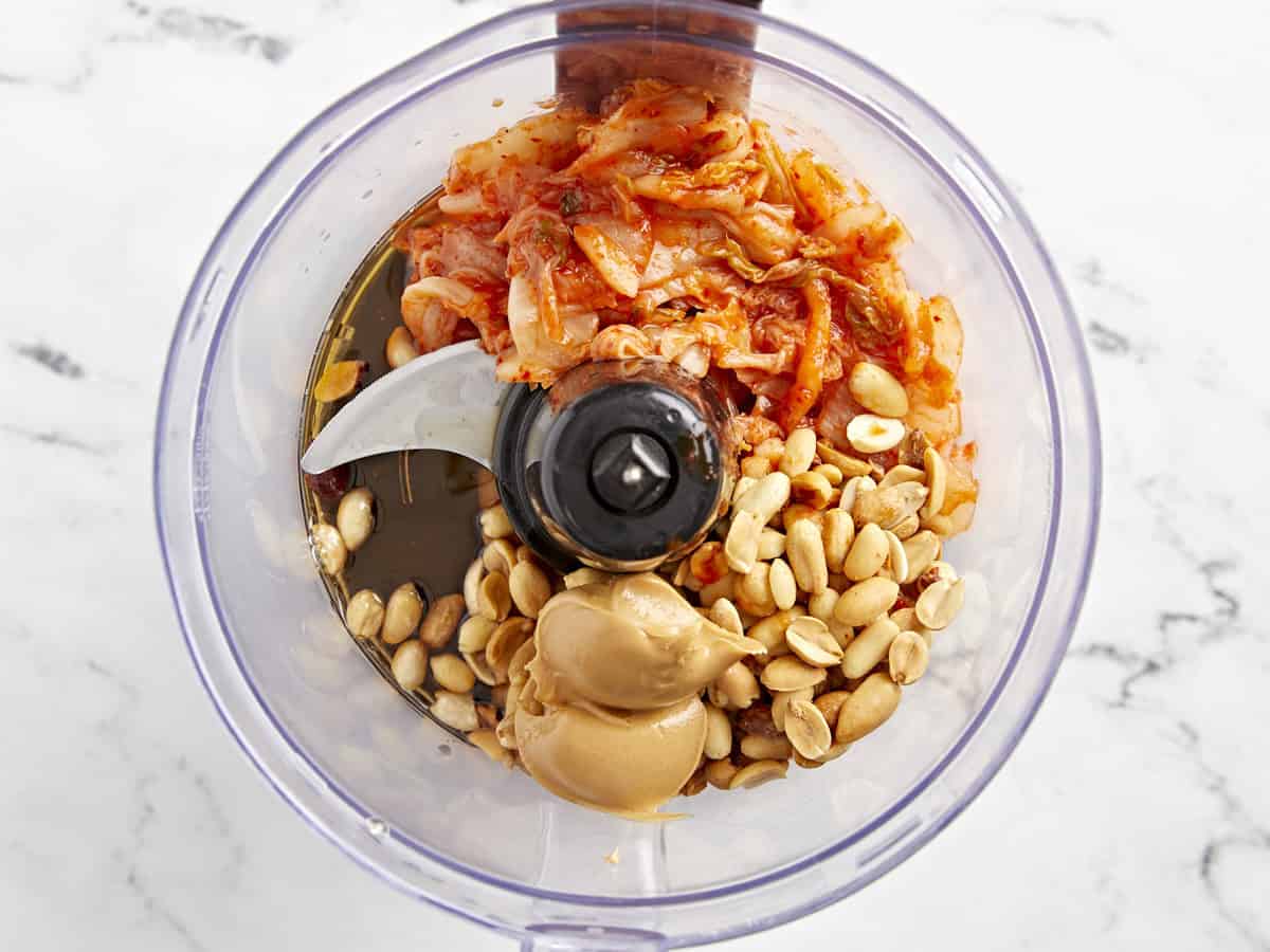 kimchi, peanuts, peanut butter, and oil in a food processor.