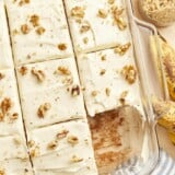 a cut banana cake missing a slice in a glass baking dish.