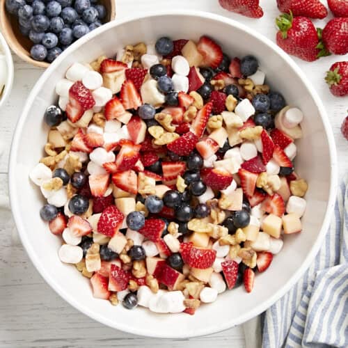 overhead view of a bowl of red white and blue fruit salad.