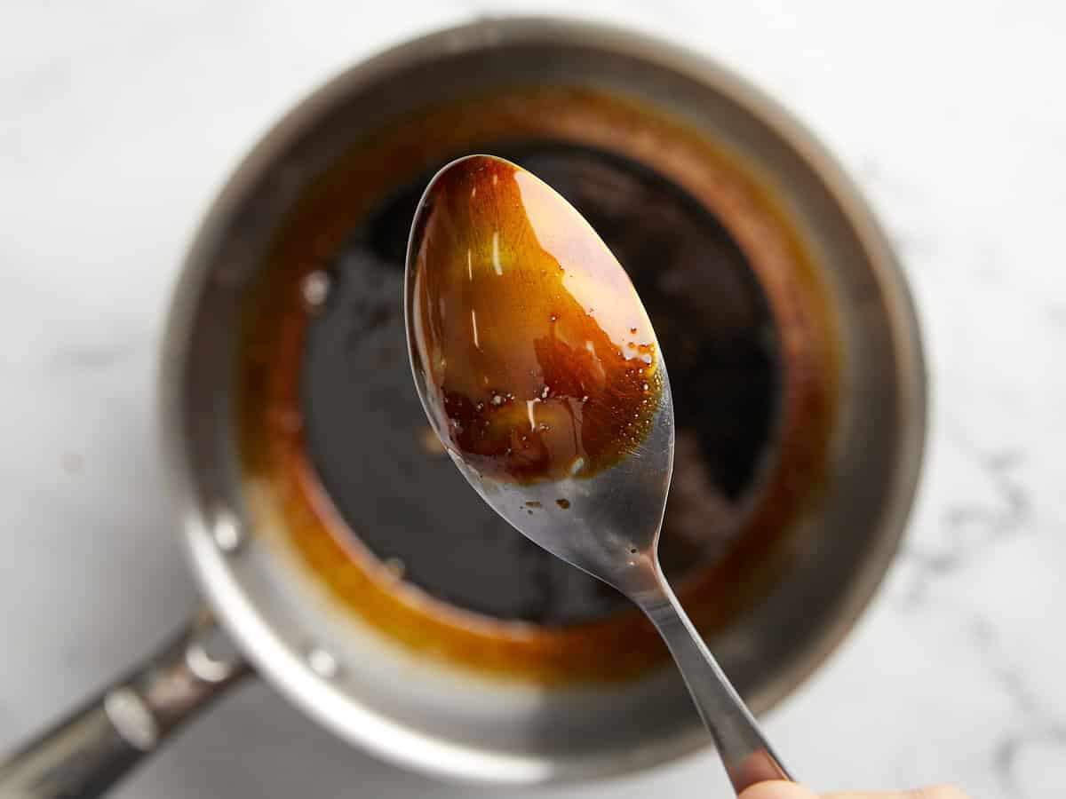 thickened balsamic glaze on a spoon.