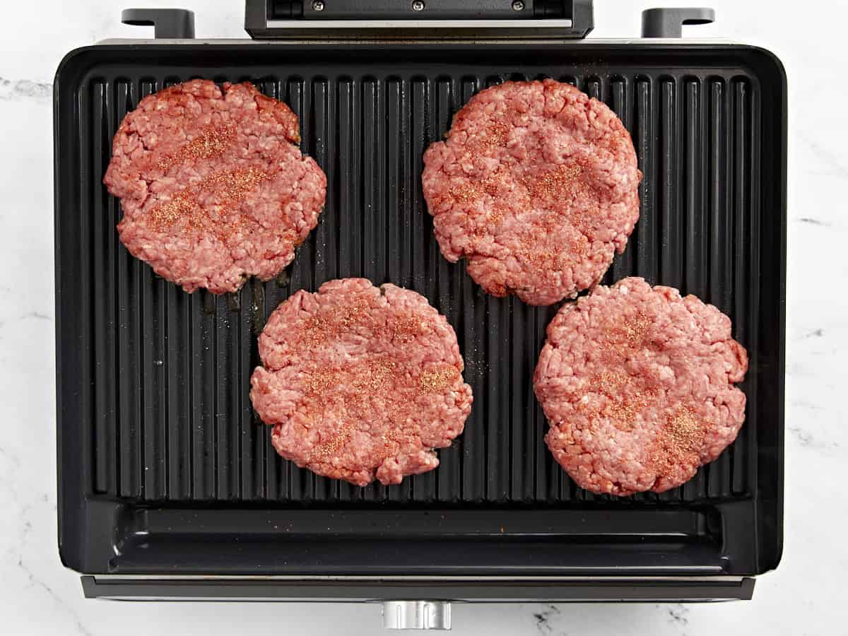 Hamburger patties on a grill.