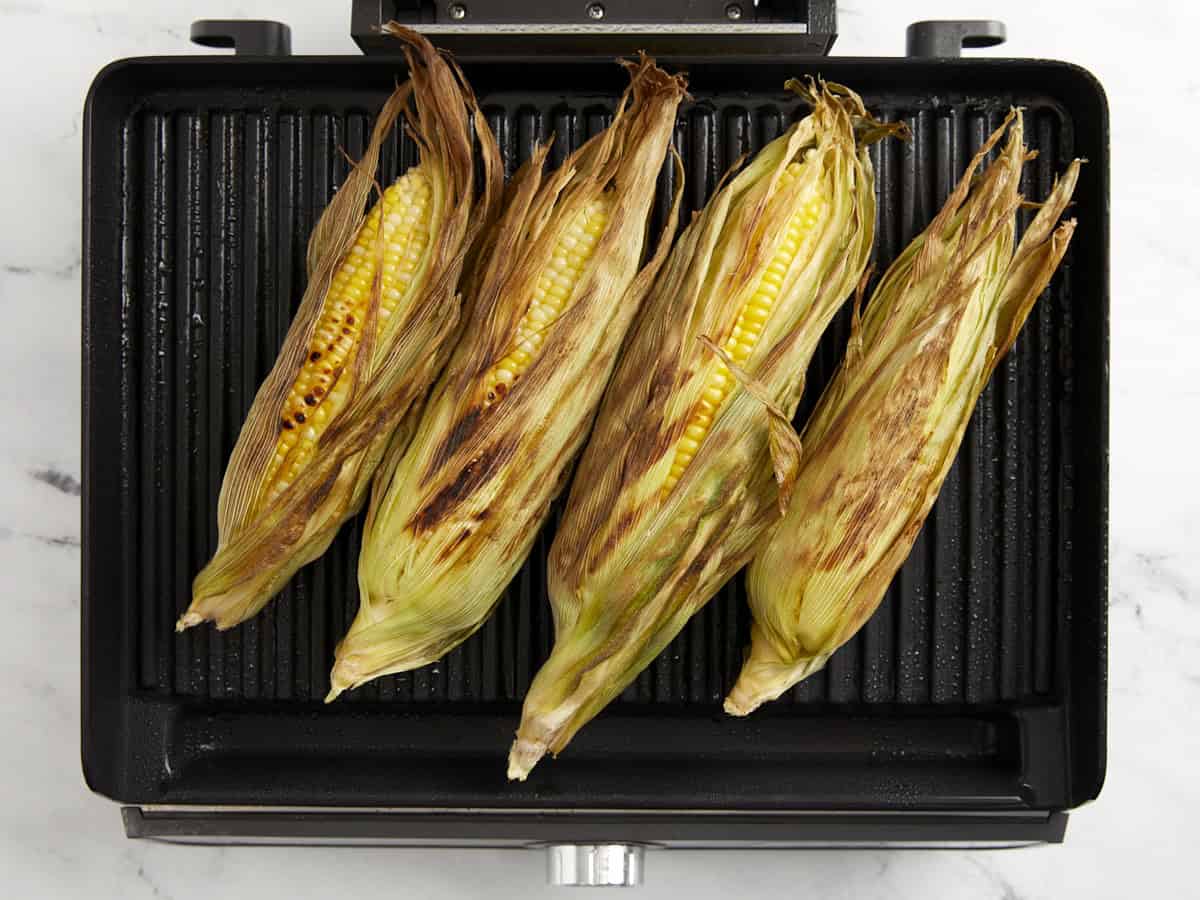 grilled ears of corn on a grill pan.