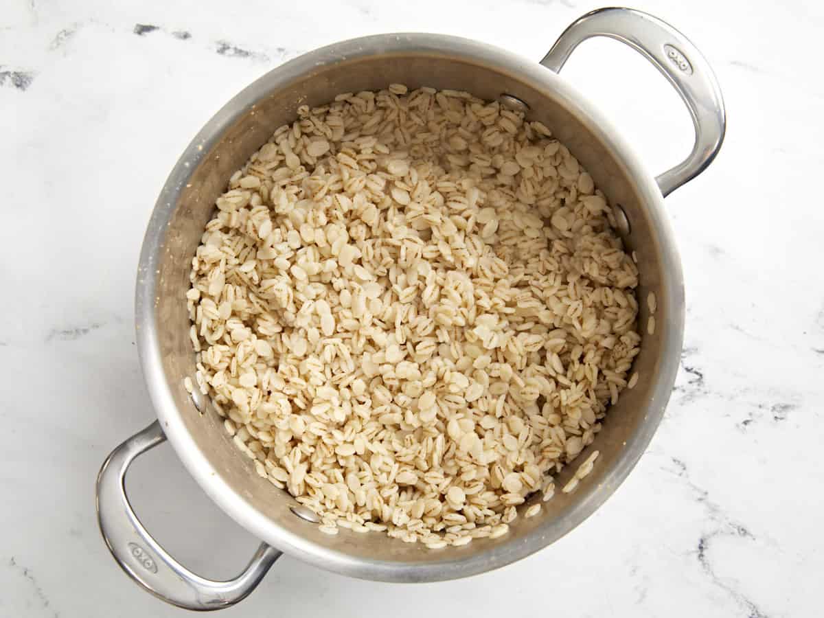 cooked fluffed barley in a pot.