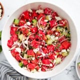 overhead view of watermelon and feta salad in a white bowl.