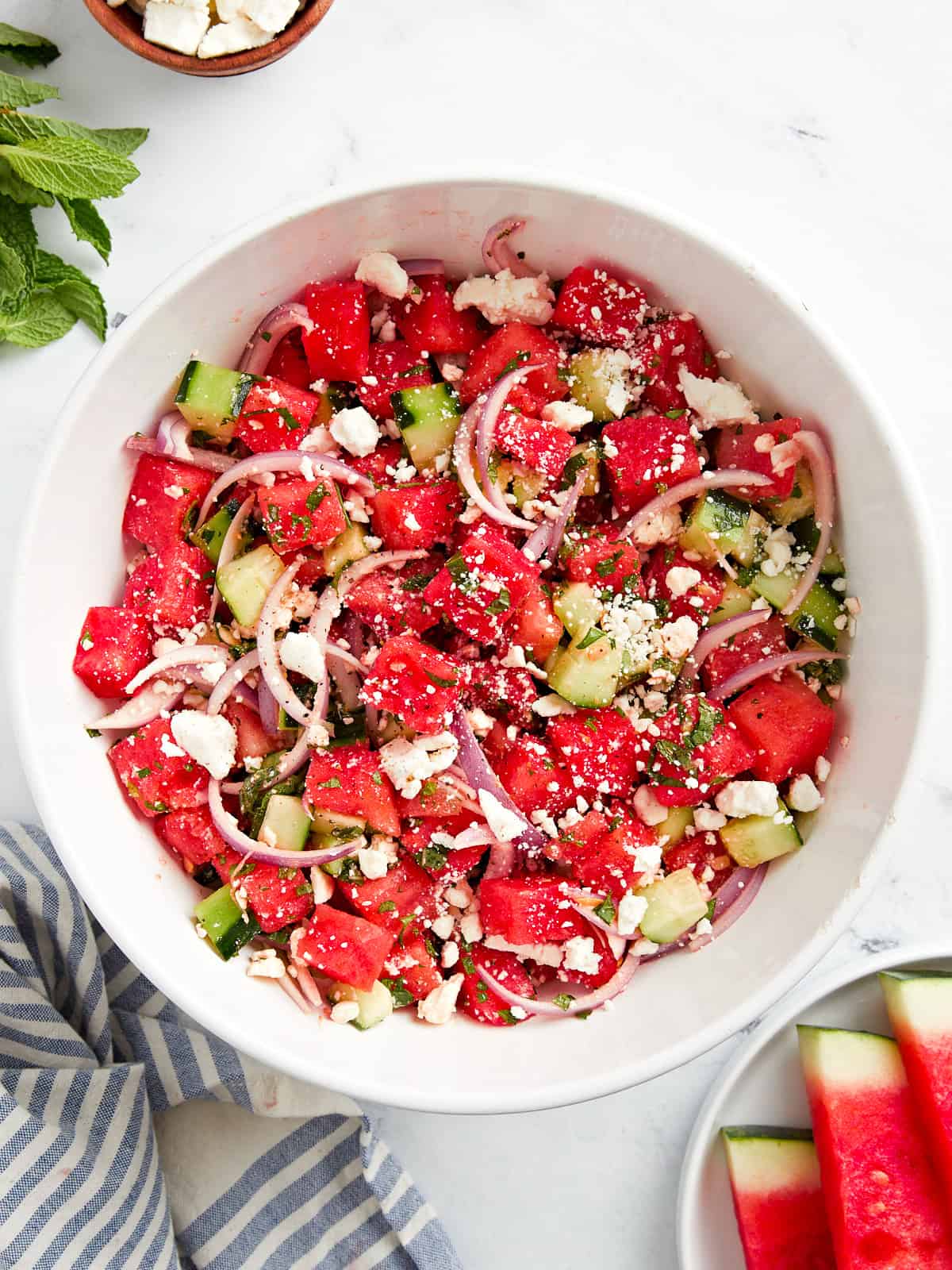 overhead view of watermelon and feta salad in a white bowl.