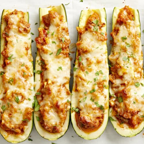 Overhead close up view of Zucchini boats on parchment paper.