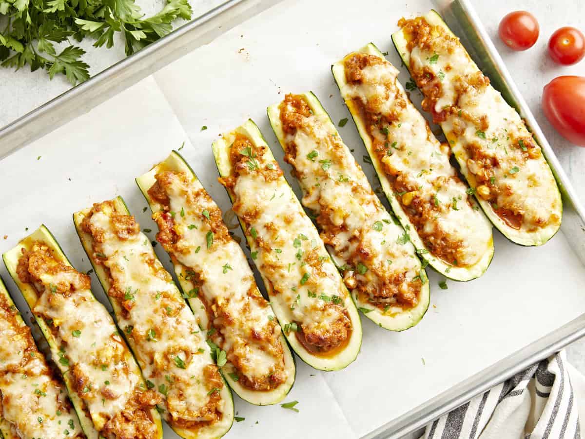 Overhead view of Zucchini boats on a parchment lined baking sheet.