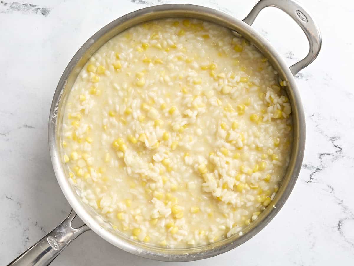 Creamy sweet corn risotto in a skillet.