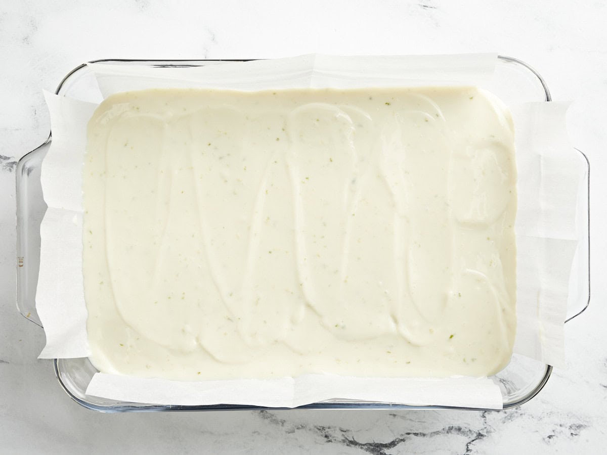 Key lime pie bars in a baking dish ready to be baked.