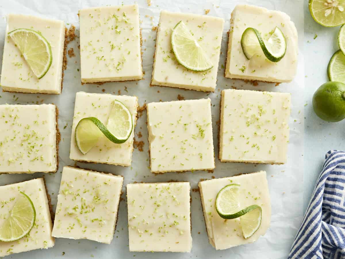 Key lime pie bars topped with lime slices.