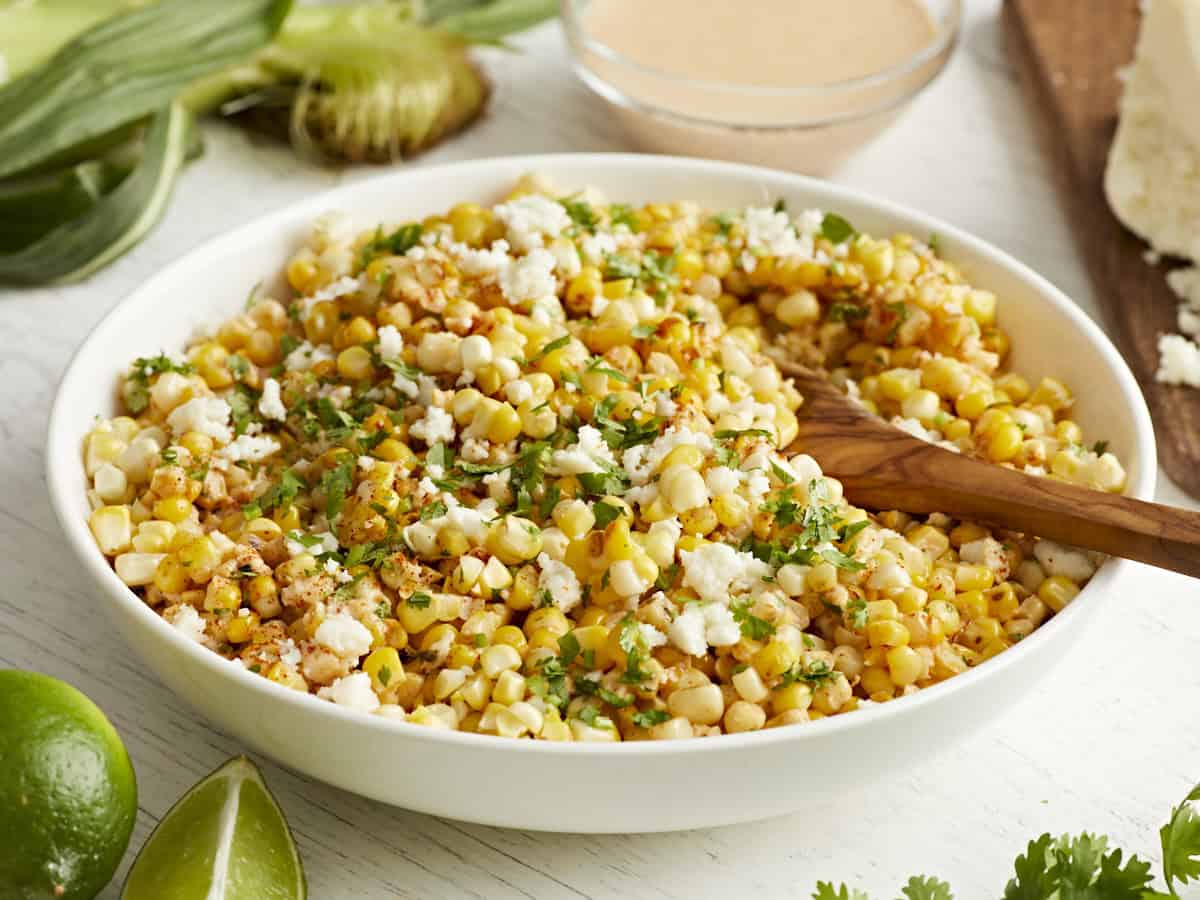 Side view of Mexican street corn salad in a bowl.