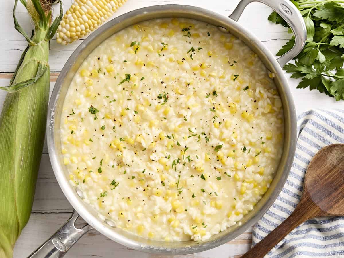 Overhead view of sweet corn risotto in a skillet.