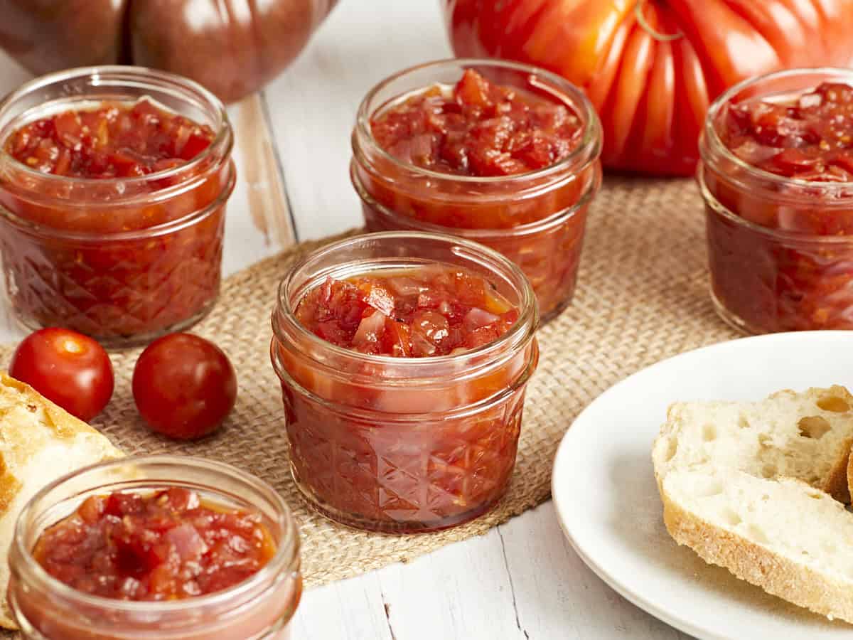 Side view of tomato relish in glass jars.