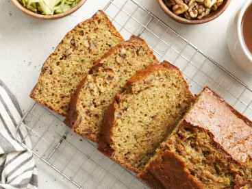 Overhead view of zucchini bread sliced on a cooling rack.