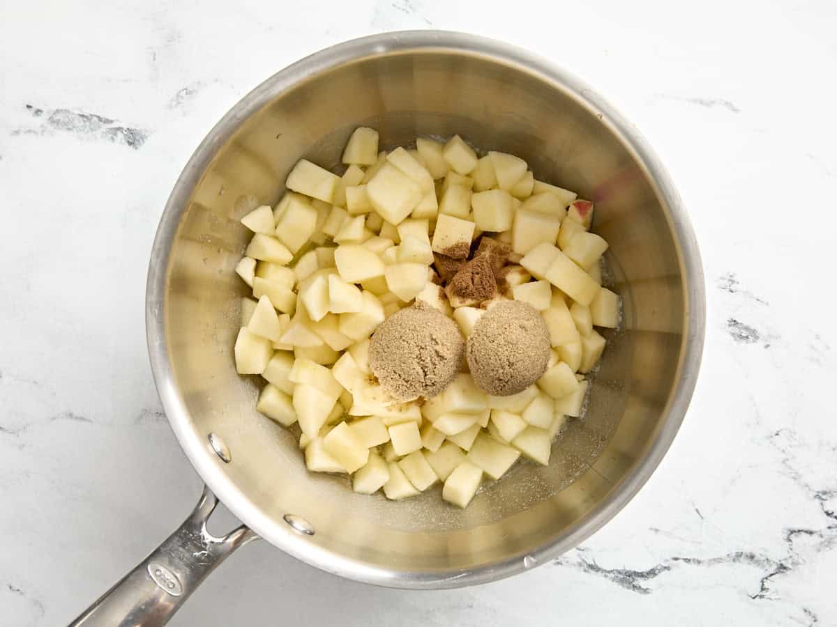 Chopped apples, brown sugar, and cinnamon in a small pot.