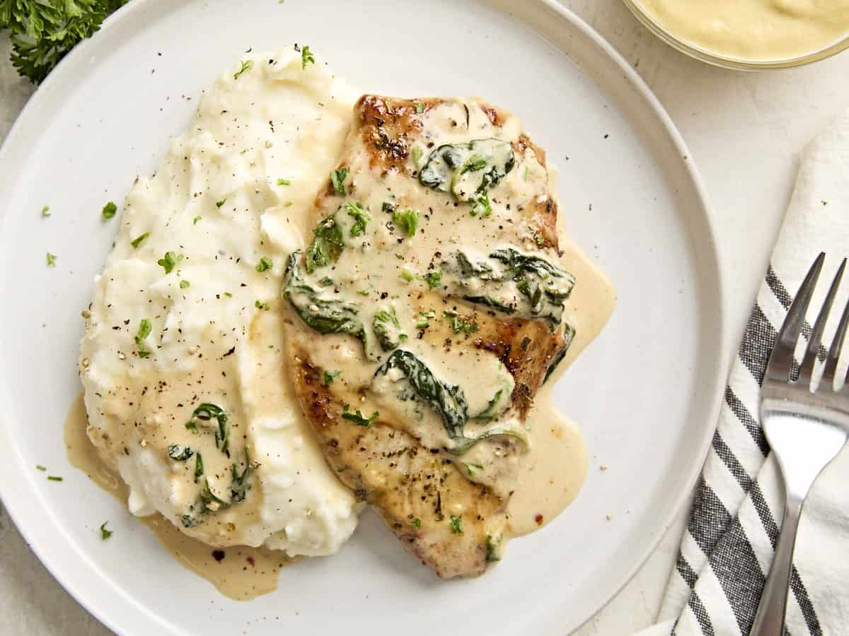 Creamy dijon chicken on a plate with mashed potatoes.