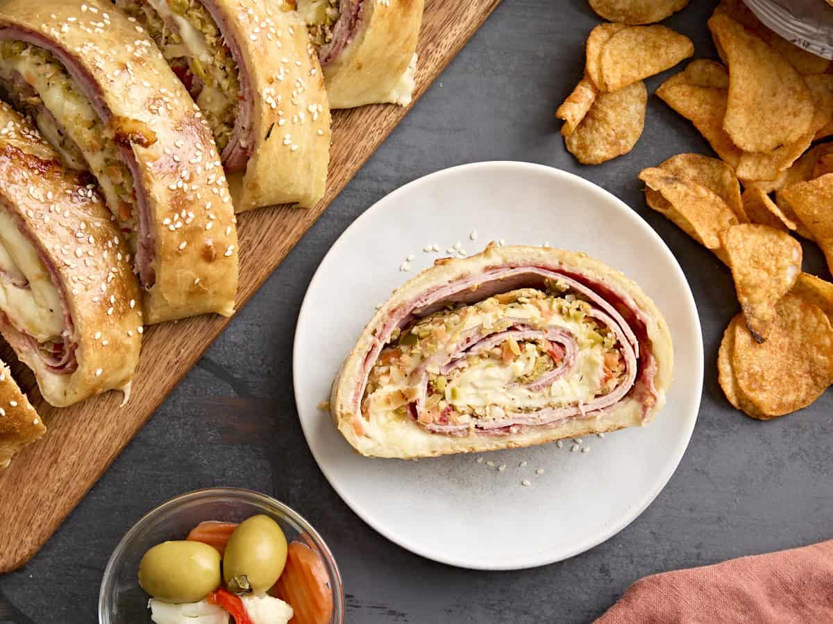 Overhead view of a muffaletta roll up on a plate 