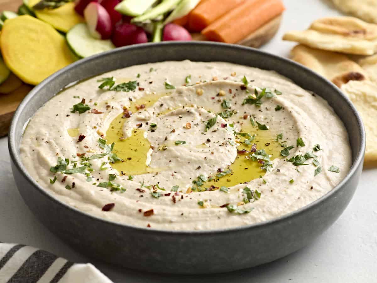 Side view of a bowl of white bean hummus