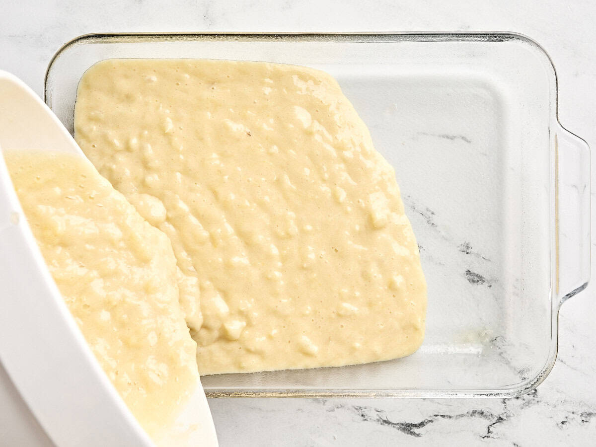 The batter for do nothing cake being poured into a baking dish.